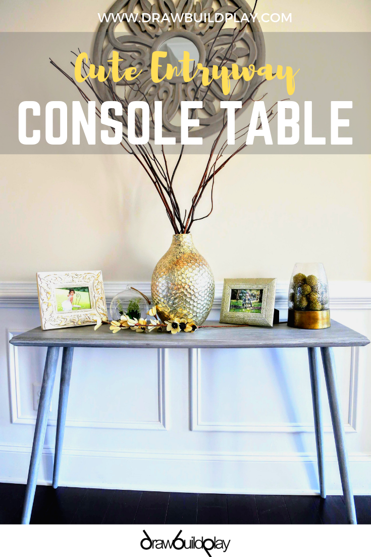 Really cute entry way console table with a gray whitewash and gold decor accents. This beautiful table will compliment your entryway, or work in any hallway you want to liven up.