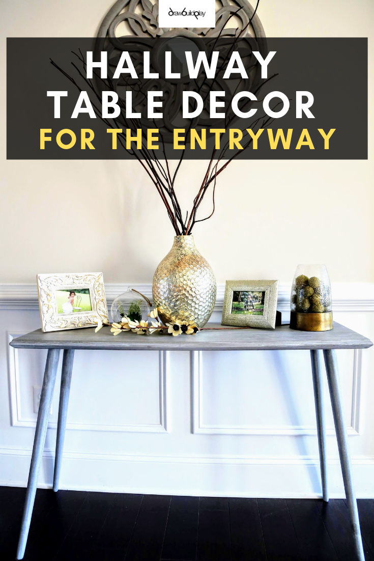 Hallway Table Decor perfect for your entryway.  This wooden farmhouse table is slim so it doesn't take up too much space, making it perfect for a hallway or entryway location.  The grey whitewash makes it a must have decor piece in your farmhouse home.  Elements of gold gives a stunning presentation for guests entering your home. #farmhouse #farmhousetable #rusticfarmhousetable #entryway #hallwaytable #consoledecor #decorentryway